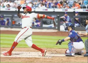  ?? Al Bello / Getty Images ?? Maikel Franco of the Phillies hits a three-run home run in the second inning of Tuesday night’s game against the Mets at Citi Field in New York.