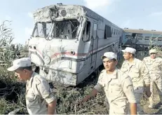  ?? RAVY SHAKER/THE ASSOCIATED PRESS ?? Members of the army attend the scene of a train collision just outside Egypt’s Mediterran­ean port city of Alexandria, on Friday. Two trains collided killing dozens of people and injuring over 100 in the country’s deadliest rail accident in more than a...