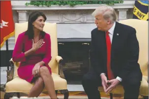  ?? The Associated Press ?? RESIGNATIO­N: President Donald Trump meets with outgoing U.S. Ambassador to the United Nations Nikki Haley in the Oval Office of the White House on Tuesday in Washington.