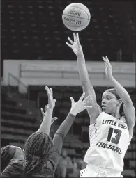  ?? Special to the Democrat-Gazette/JONATHAN BACHMAN ?? UALR Trojans guard Sharde Collins (13) shoots in front of two Louisiana-Lafayette defenders during the Trojans’ 79-71 loss to the Ragin’ Cajuns on Saturday in the semifinals of the Sun Belt Tournament at Lakefront Arena in New Orleans. Collins finished...