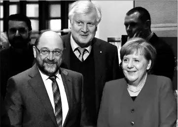  ?? — AFP photo ?? (From right) Merkel, Seehofer and Schulz enter the conference room at the headquarte­rs of Social Democrats Party (SPD) for coalition talks to form a new government.