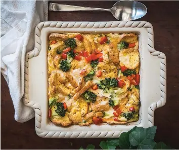  ?? ?? This image above shows a variation of a baked egg casserole called strata that is made with red bell peppers by blogger Lauren Lane. (Lauren Lane
via AP)