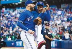  ?? Canadian Press photo ?? Toronto Blue Jays centre fielder Kevin Pillar, left, is congratula­ted by teammate Marcus Stroman after making an inning-ending catch in fifth inning American League MLB baseball action against the Detroit Tigers in Toronto on Saturday.