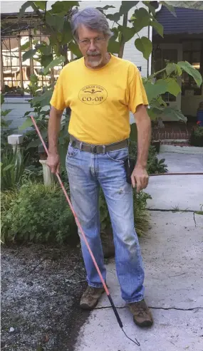  ??  ?? Columnist Frank Hyman shows off his chanterell­e hook. It’s not necessary to wear a chanterell­ecolored shirt while using the hook!