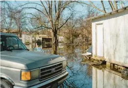  ?? ?? A neighborho­od is swamped with standing water Jan. 4 after rain in Earle, due to the town’s faulty drainage system. Smith has already dispatched crews to work on storm drains.