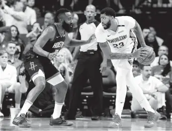  ??  ?? New Orleans Pelicans forward Anthony Davis handles the ball while Houston Rockets guard James Harden defends during their NBA clash at Toyota Center in Houston, Texas, on Wednesday. The Pelicans won the opener 131-112. — Reuters