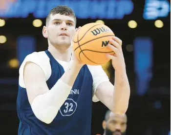  ?? K.C. ALFRED/SAN DIEGO UNION-TRIBUNE ?? Uconn’s Donovan Clingan shoots during a practice for a Sweet 16 game against San Diego State at the TD Garden on Wednesday in Boston.