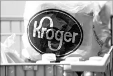  ?? AP Photo/Rogelio V. Solis ?? In this 2017 file photo, bagged purchases from a Kroger grocery store sit in a shopping cart in Flowood, Miss.