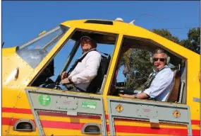  ?? (Arkansas Democrat-Gazette/Cristina LaRue) ?? Tommy Anderson, president and chief executive officer of Tommy’s Flying Service (left), takes U.S. Rep. Bruce Westerman on a flight in a crop duster Thursday in Sherrill.