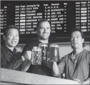  ?? Ted Rhodes, Calgary Herald ?? National Beerhall’s Victor Choy, left, his brother Jim, right, and Jon Molyneux enjoy a cold craft draught.