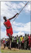  ?? ?? A Maasai man throws a javelin Dec. 10 as he competes in the Maasai Olympics.