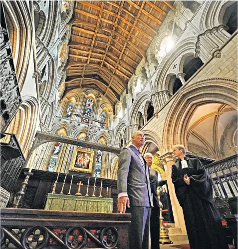  ??  ?? The Prince of Wales meets with Canon Dagmar Winter, the rector of Hexham Abbey, to see restoratio­n work on medieval paintings during a visit to Northumber­land yesterday