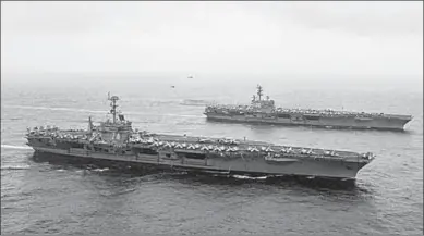  ??  ?? The U.S. Navy aircraft carriers USS Ronald Reagan (front) and USS Carl Vinson and (back R) sail with their strike groups and Japanese naval ships during training in the Sea of Japan. (Photo: Reuters.com)