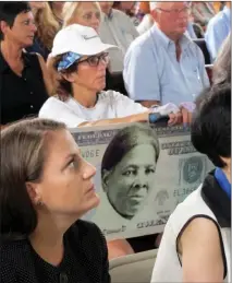  ?? AP PHOTO BY CAROLYN THOMPSON ?? A woman holds a sign supporting Harriet Tubman for the $20 bill Monday during a town hall meeting at the Women’s Rights National Historical Park in Seneca Falls, N.Y.