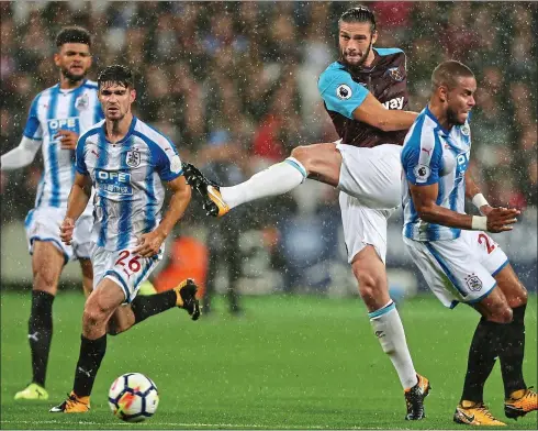  ??  ?? Muscling in:
Andy Carroll gave the Huddersfie­ld defence a tough time last night