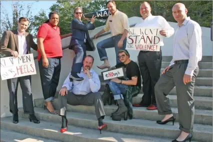  ?? Severo Avila / Rome News-Tribune ?? Lee Neidrach, Oliver Robbins, Mark Webb, Robert Smyth, Russell Evans, Steven White, Micah Duke and Chris Farrell slipped into some high heels and boots for a photo shoot promoting the upcoming “Walk a Mile in her Shoes” event which takes place Friday,...