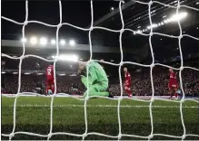  ?? JON SUPER — THE ASSOCIATED PRESS ?? Liverpool’s goalkeeper Adrian, bottom, kneels in dejection after he fails to save the ball as Atletico Madrid’s
Marcos Llorente scores his side’s second goal during a Champions League match on March 11.