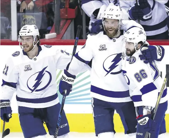  ?? PATRICK SMITH/GETTY IMAGES ?? Lightning forward Nikita Kucherov, right, celebrates a goal with teammates Brayden Point, left, and Victor Hedman on Tuesday as Tampa Bay won 4-2 in Game 3 of the Eastern Conference final in Washington, D.C., to cut the Capitals’ series lead to 2-1.