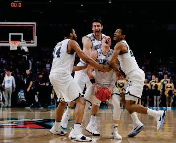  ?? ASSOCIATED PRESS ?? VILLANOVA GUARD DONTE DIVINCENZO (CENTER) celebrates with teammates at the end of Monday’s NCAA national championsh­ip game against Michigan in San Antonio. Villanova won 79-62.