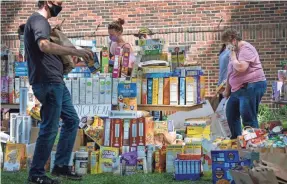  ?? JACK GRUBER/USA TODAY ?? People donate food and cleanup items at the Holy Trinity Lutheran Church in Minneapoli­s on May 31.