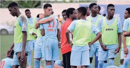  ?? IAN ALLEN PHOTOS ?? Members of the St George’s College team console each other after they lost on penalties to St Andrew Technical at the Constant Spring Complex yesterday.