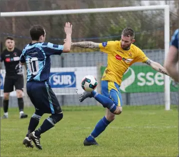  ??  ?? Decky Downes of North End United improvises to get the ball past David Somers of St. Mochta’s.