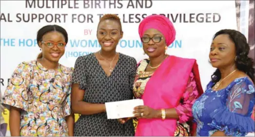  ??  ?? Mrs. Ambode (2nd right) presenting cheque to one of the beneficiar­ies of her pet project