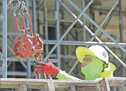  ?? AP PHOTO/ALAN DIAZ ?? In this Thursday, June 15, photo, a constructi­on worker continues work on a condominiu­m project in Coral Gables, Fla. The Labor Department has released its U.S. jobs report for June.