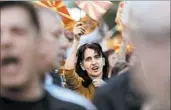  ?? BORIS GRDANOSKI/AP ?? People wave Macedonian flags during a peaceful protest in front of the EU mission building Friday in Skopje.