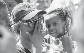  ?? STEPHEN MATUREN/GETTY IMAGES ?? Diamond Reynolds, holding her daughter, speaks to a crowd in Minnesota. They were in the car with Philando Castile July 6th, when an officer fatally shot him.