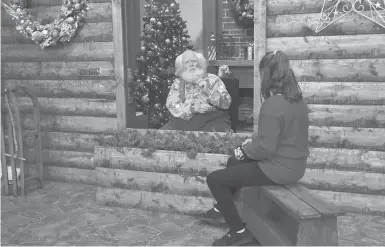  ?? JIM MONE/AP ?? Sid Fletcher, dressed up as Santa Claus, sits behind a barrier as he listens to Kendra Alexander, of St. James, Minnesota, during her visit to The Santa Experience on Nov. 15 at the Mall of America near Minneapoli­s.