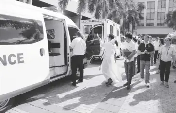  ?? ?? Gov. Arthur Defensor Jr., Provincial Administra­tor Raul Banias and Hospital Management Office chief Dr. Paz Calopiz lead the turnover of the six new ambulances to six district hospitals in Iloilo at the provincial capitol grounds on Monday morning, Feb. 19.