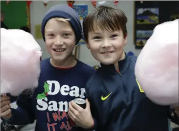  ??  ?? Daniel Hannon and Max Walshe enjoying some candy floss at the annual St Cronan’s Christmas Fair.