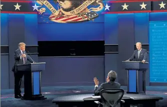  ?? DOUG MILLS / NYTNS ?? President Donald Trump, left, debates former Vice President Joe Biden, the Democratic presidenti­al nominee, in Cleveland on Sept. 29. Both candidates will appear on major television networks tonight at the same time for separate town hall events. They were previously scheduled to debate tonight.