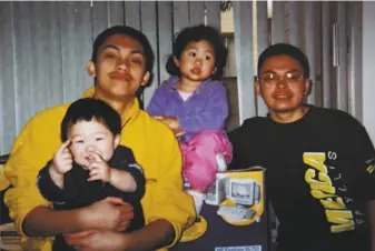  ??  ?? Top: Laudemer Arboleda (back left) in a family photo.
Right: Jeannie Atienza holds her son Laudemer. Arboleda was fatally shot by an officer while trying to flee in 2018. A federal civil rights lawsuit filed by Atienza is inching its way through the courts.