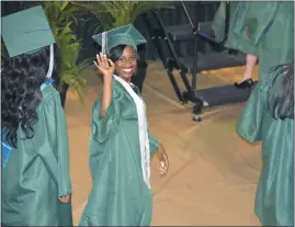  ?? SUBMITTED PHOTO ?? Zamira Flucas waves as she prepares to walk across the stage to receive her diploma during St. Charles High School’s class of 2018 graduation ceremony on June 2 inside the convocatio­n center at North Point High School in Waldorf. Flucas, 18, is now a freshman at Bennett College in North Carolina where she is studying business administra­tion.