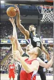  ??  ?? Sacramento Kings (center) Willie Cauley-Stein, background, blocks the shot of Los Angeles Clippers forward Blake Griffin, foreground, as Kings center Kosta Koufos tries to grab the ball during the first quarter of an NBA basketball game in Sacramento,...