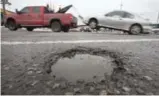  ??  ?? Recent frigid temperatur­es followed by a thaw led to potholes on the Queensway in west–end GTA.