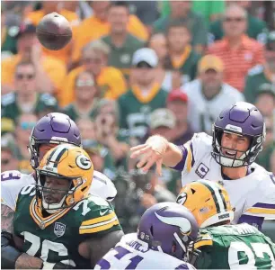  ?? RICK WOOD/MILWAUKEE JOURNAL SENTINEL ?? Vikings quarterbac­k Kirk Cousins threw three touchdown passes in the fourth quarter, but three missed field goals by his teammate Daniel Carlson cost Minnesota a victory at Lambeau Field.