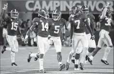  ?? STEPHEN M. DOWELL/TRIBUNE NEWS SERVICE ?? Alabama defensive players celebrate with defensive back Deionte Thompson (14) after he intercepte­d a pass against Louisville on Sept. 1.