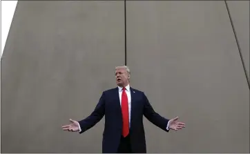  ?? THE ASSOCIATED PRESS ?? President Donald Trump speaks in March in front of a border wall prototype in San Diego.