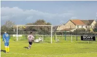  ??  ?? Rob Jones knocks in the Llantwit Major equaliser