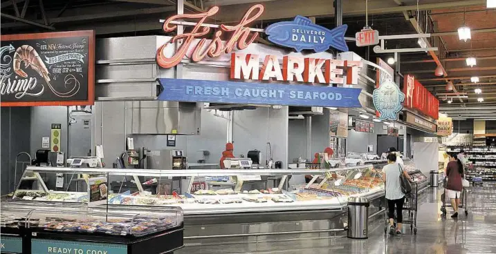  ?? Gary Fountain ?? The recently opened H-E-B in Tanglewood has a fish market, as well an in-house restaurant, a sushi bar, bulk hummus and a takeout barbecue booth.