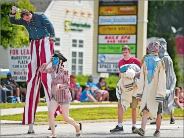  ?? SEAN D. ELLIOT/THE DAY ?? Members of Flock Theater march in Groton’s annual Independen­ce Day Parade down Long Hill Road on Wednesday.