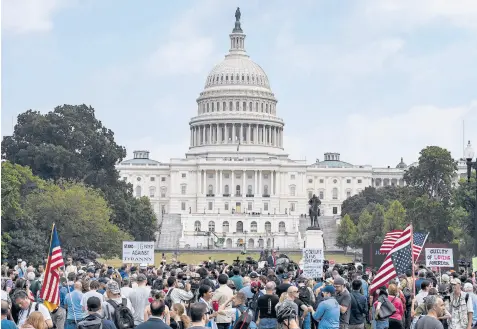  ?? KENNY HOLSTON/THE NEW YORK TIMES ?? Far-right demonstrat­ors and journalist­s gather Saturday near the Capitol in Washington, during the “Justice for J6” rally. The crowd was sparse and incidents were few.