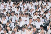  ??  ?? Students leave an exam venue at the Thammasat University Rangsit Campus in Pathum Thani.