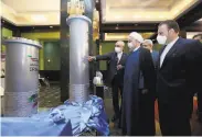  ?? Iranian Presidency Office ?? President Hassan Rouhani (second from right) views a nuclear technology exhibit Saturday in Tehran.