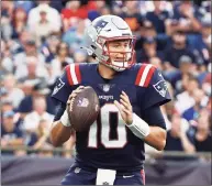  ?? Winslow Townson / Associated Press ?? New England Patriots quarterbac­k Mac Jones looks to pass against the Miami Dolphins during the second half last Sunday.