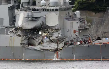  ?? EUGENE HOSHIKO — THE ASSOCIATED PRESS ?? Damaged part of USS Fitzgerald is seen at the U.S. Naval base in Yokosuka, southwest of Tokyo Sunday. Navy divers found a number of sailors’ bodies Sunday aboard the stricken USS Fitzgerald that collided with a container ship in the busy sea off Japan.