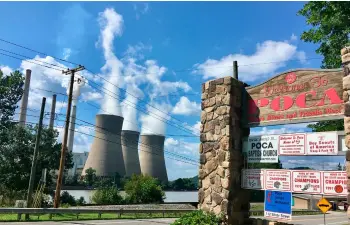  ??  ?? In this Aug. 23 photo, American Electric Power’s John Amos coal-fired plant in Winfield, W.Va., is seen from the town of Poca across the Kanawha River. AP PhoTo/John rABy
